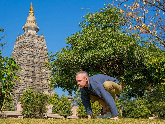 йогин в бакасане на фоне дворца махабодхи